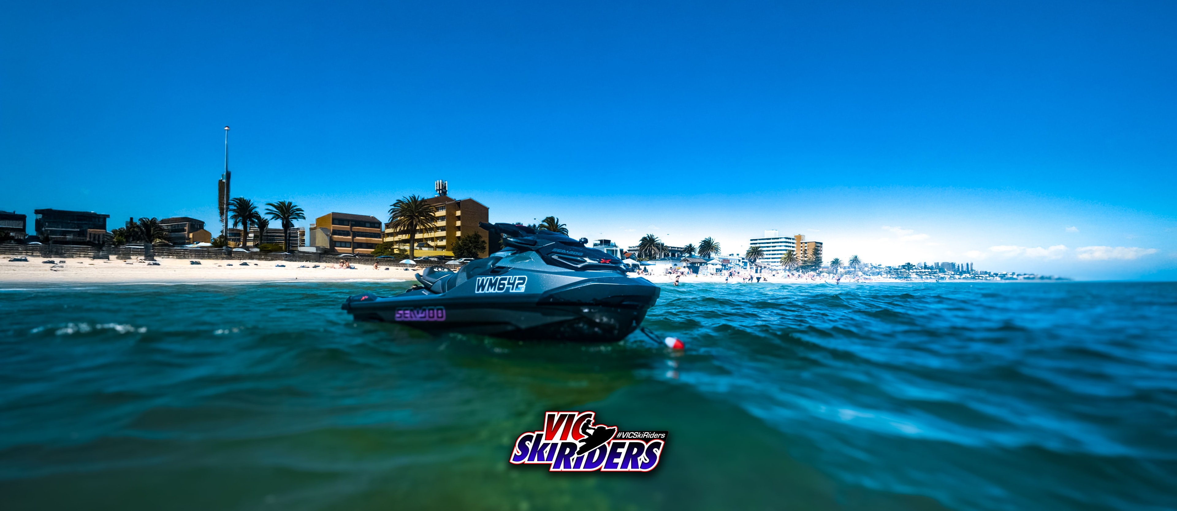 Sea-Doo WM642 floating in turquoise water at St Kilda beach with city skyline